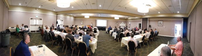 Meeting room with participants listening to a speaker during the 2023 Forum.