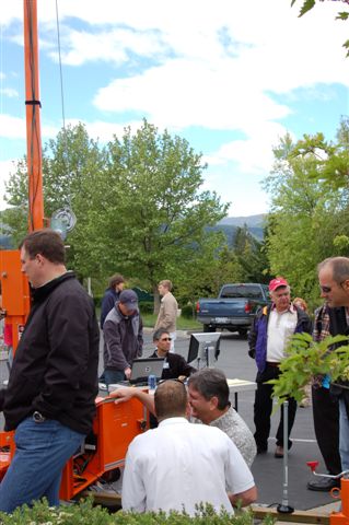 Forum participants view equipment demonstrations outside.